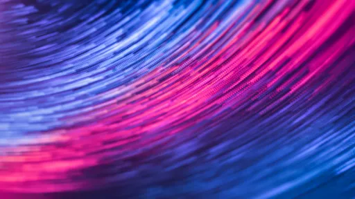 A dynamic abstract image featuring swirling pink and blue lights in motion, creating a futuristic feel.